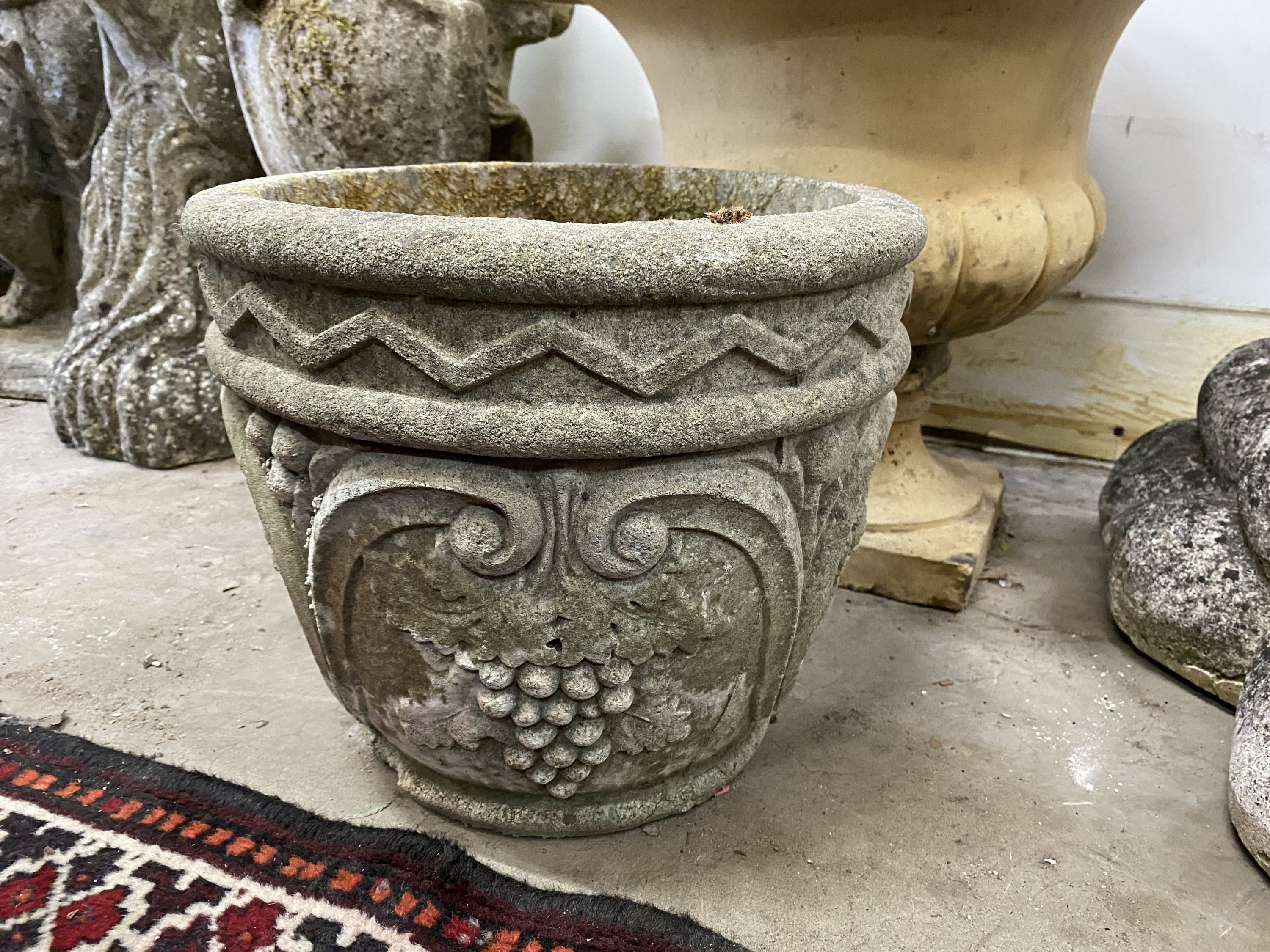 An earthenware campana garden urn, diameter 45cm, height 42cm together with a smaller reconstituted stone garden planter